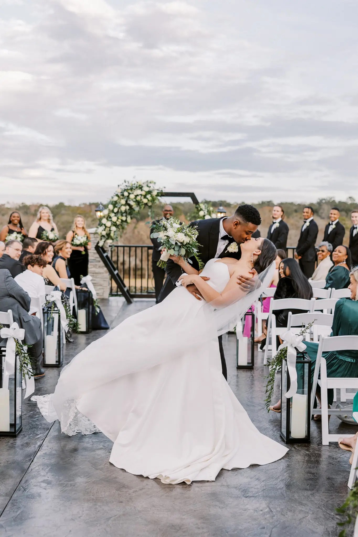 Wedding kiss dip in middle of aisle