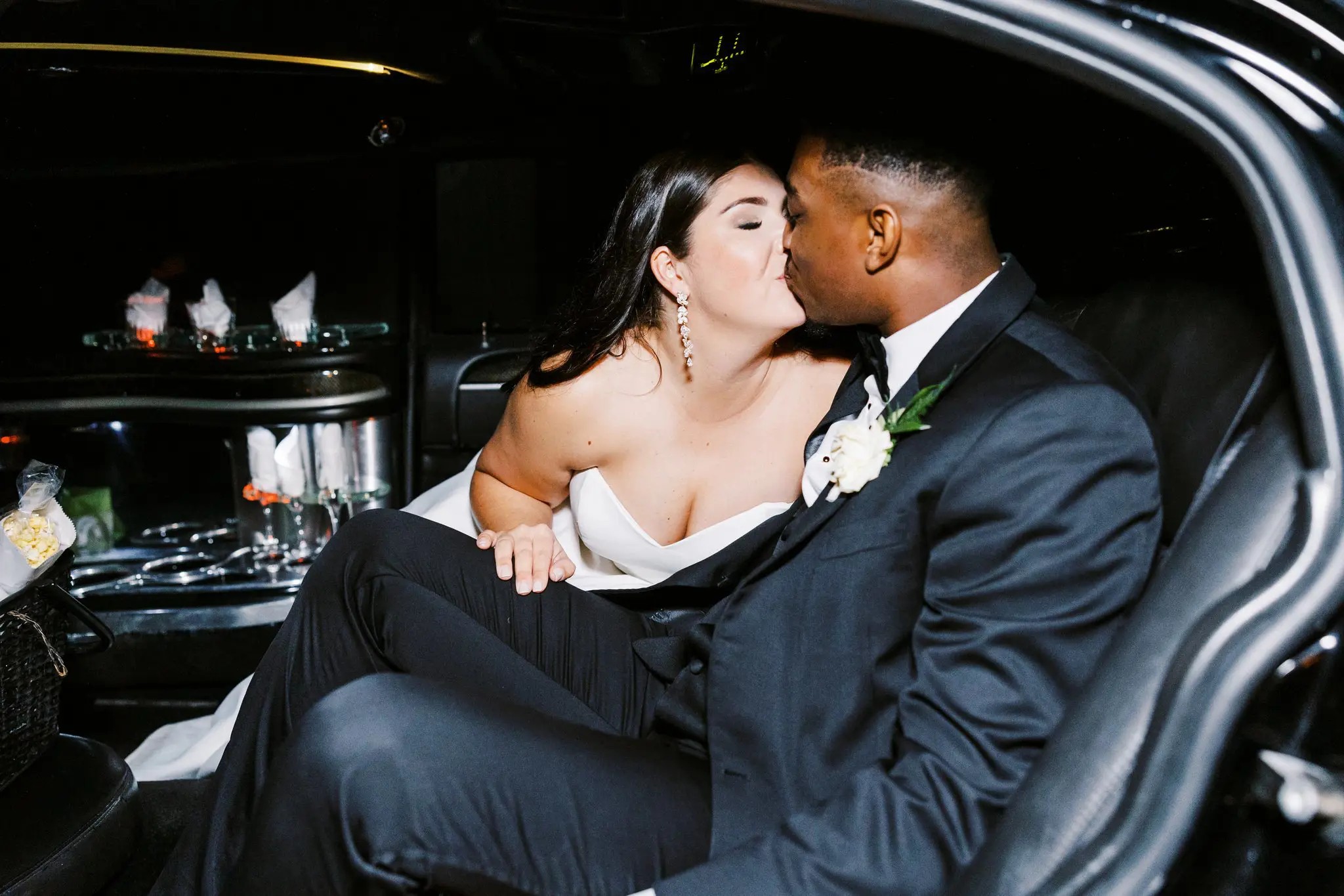 Wedding get away car kiss
