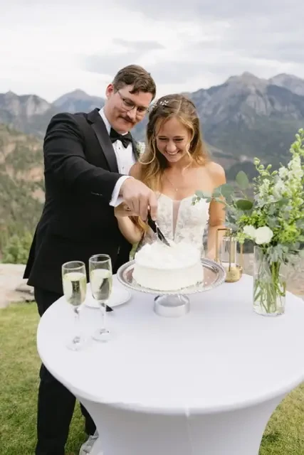 Bride and Groom Cutting Cake at Gold Mountain Ranch in Colorado